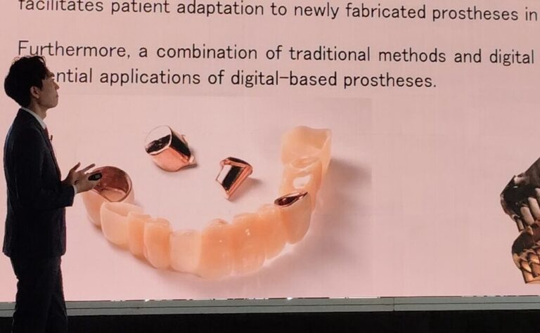 Presenter on stage beside a slide titled 'Conclusion of my presentation', showing dental dentures and a jaw model.